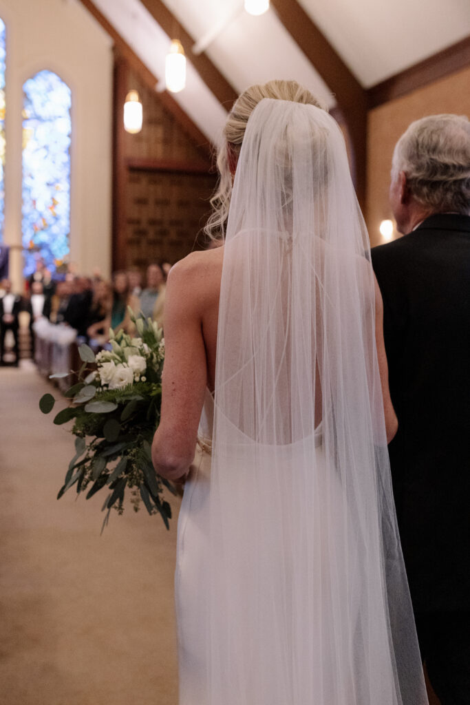 Bride and dad walking down the aisle for her ceremony in spartanburg sc