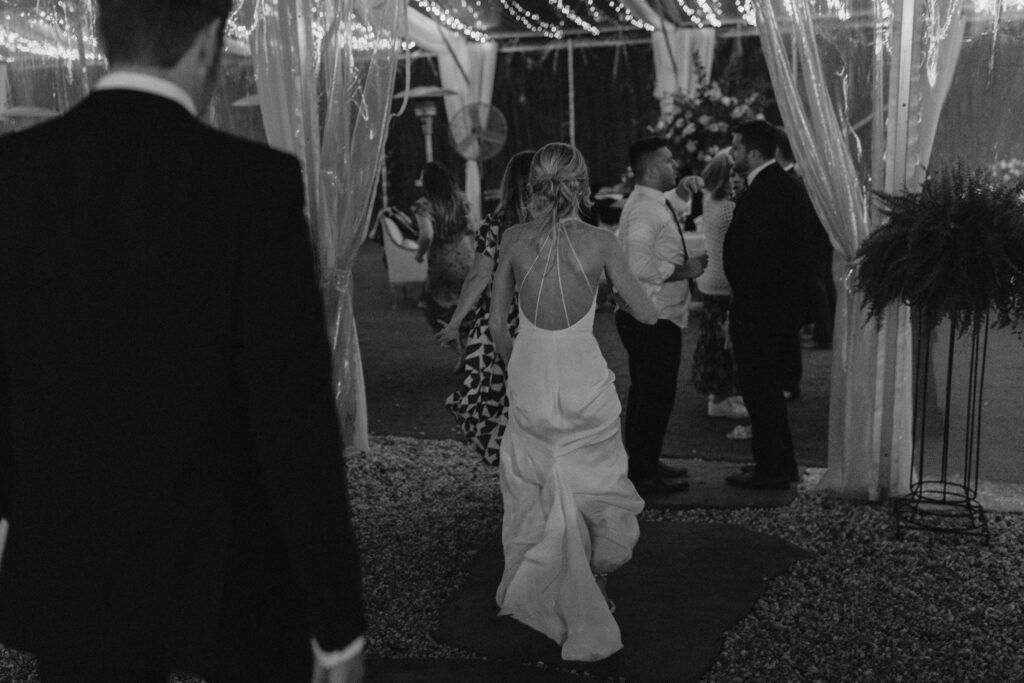 bride running inside to her wedding reception