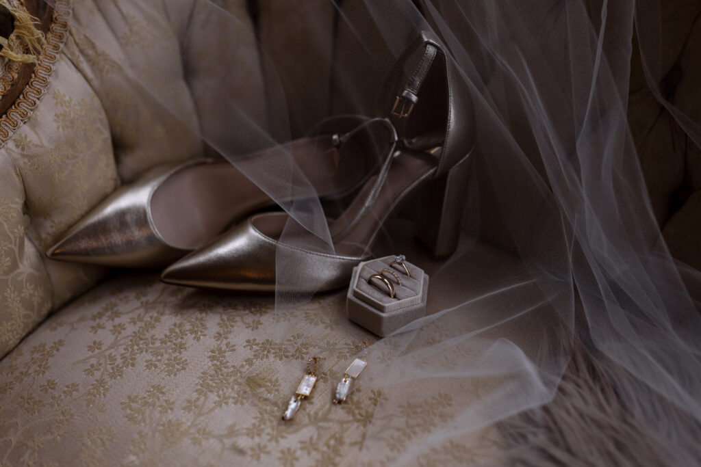 Bride's shoes, rings, earrings, and veil on a chair for her wedding in spartanburg sc