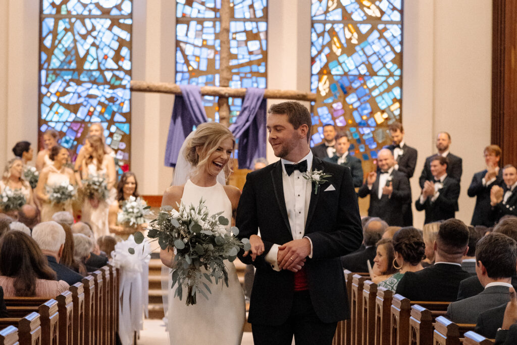 Bride and groom leaving the ceremony down the aisle