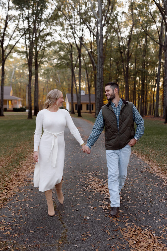 couple walking and holding hands in a fall setting