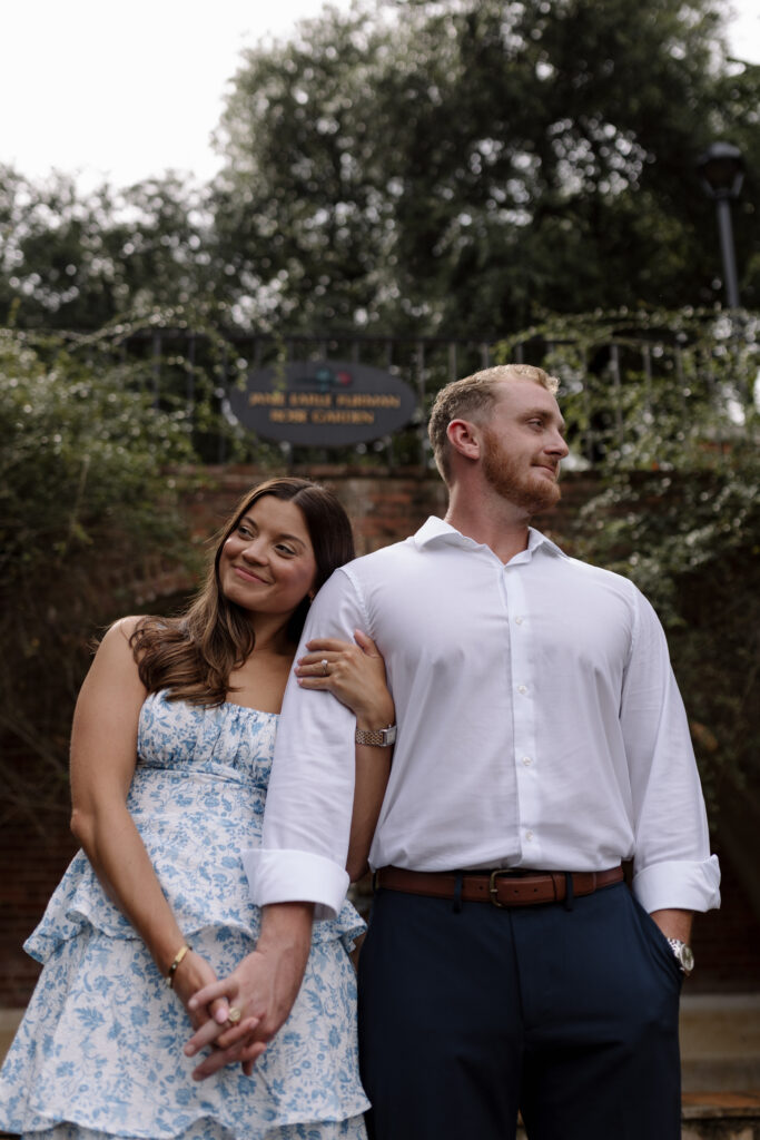 couple looking left and right from below while holding hands