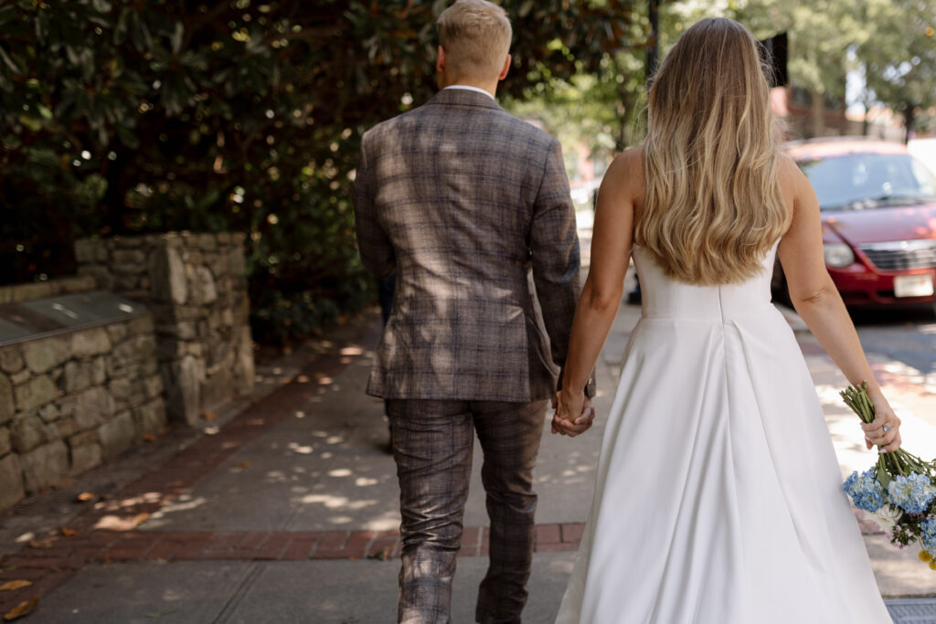 bride and groom walking down the street from behind