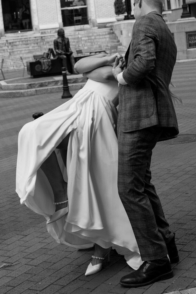 Groom dips bride while dancing downtown Greenville SC