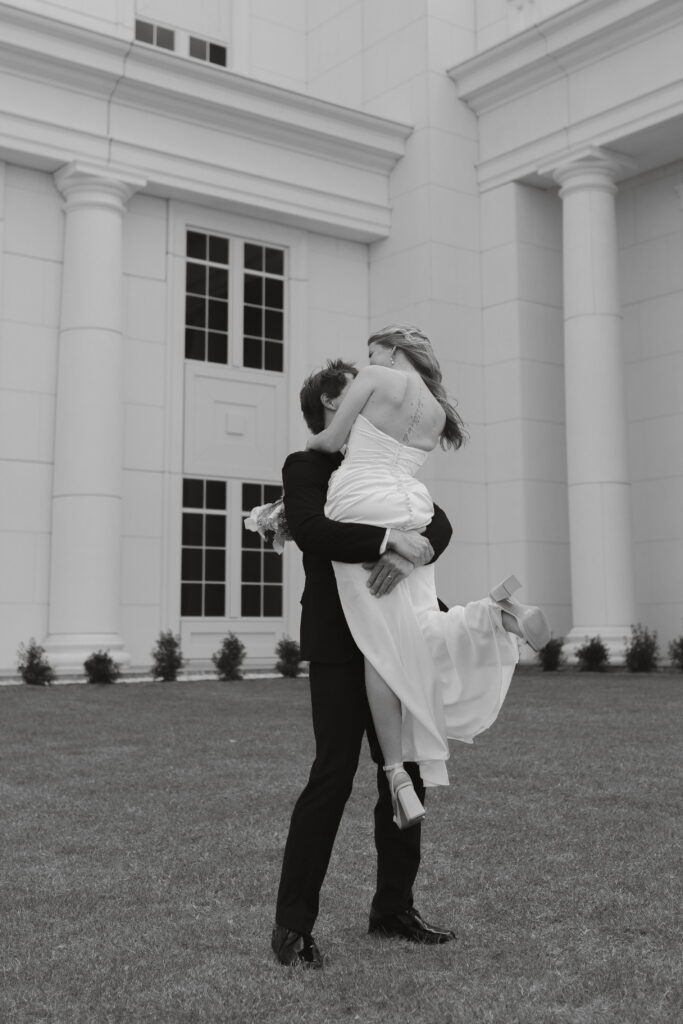 Groom spinning bride around outside the spartanburg county courthouse