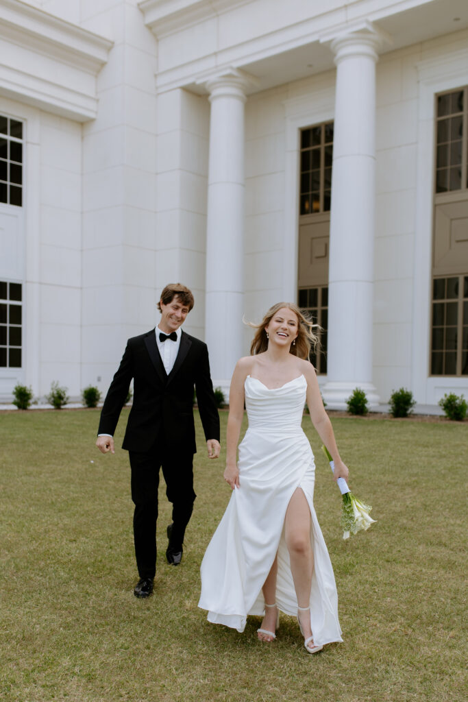 Bride and groom running around the spartanburg county courthouse after their elopement. 