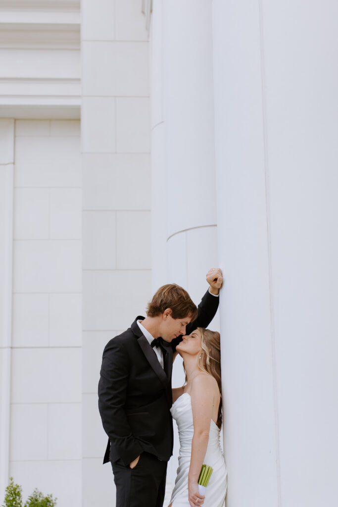 Intimate moment between bride and groom outside of courthouse after elopement. 