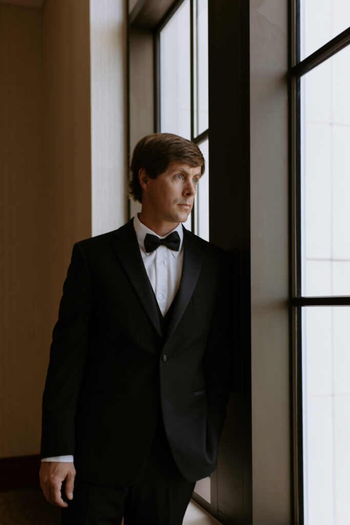 Quiet moment of the groom before his Spartanburg elopement in the courthouse by the windows