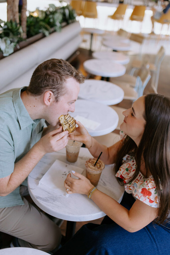 greenville sc couple feeding each other in a coffee shop