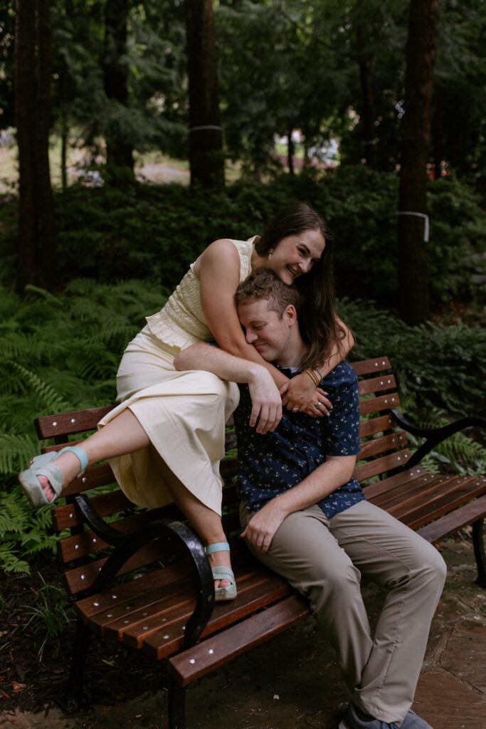 couple cuddling on bench and laughing in falls park