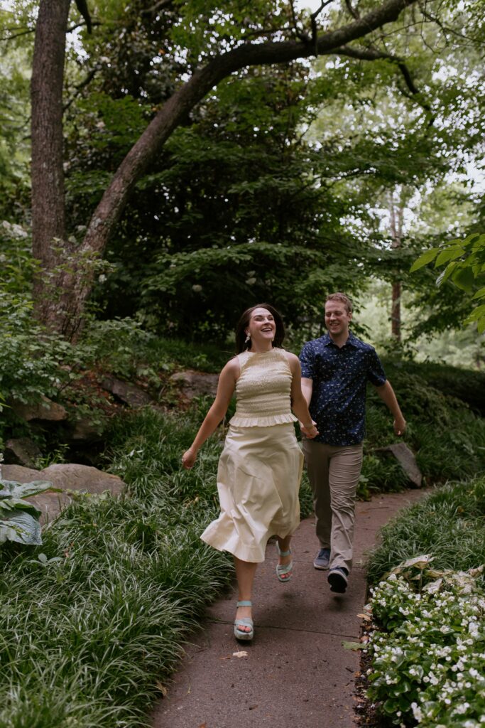 couple in greenville sc running through winding path in Falls Park
