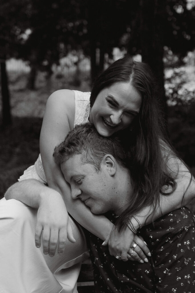 close up of couple in greenville sc cuddling on falls park bench