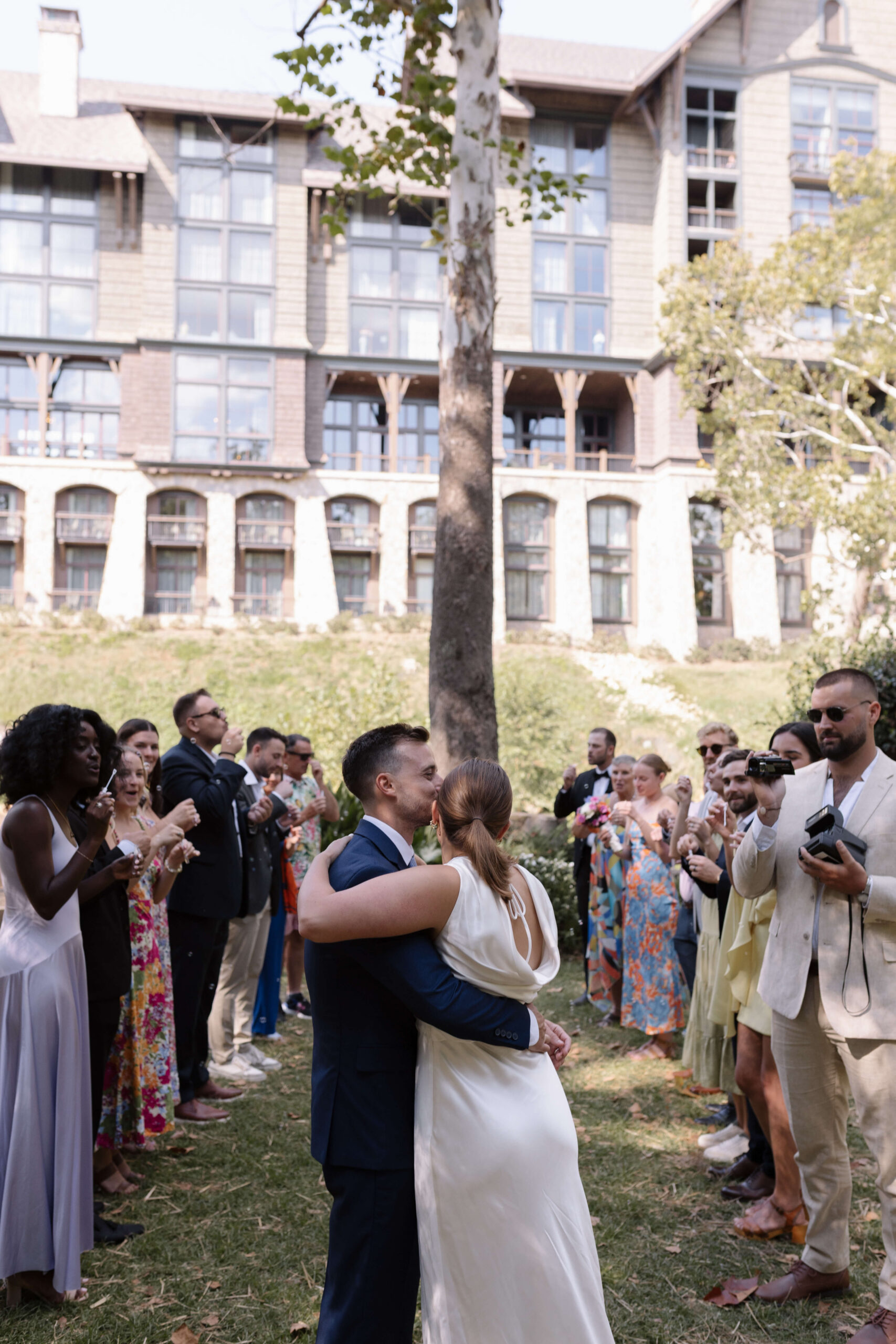 Emmy and Stu embracing while facing their friends and family after their elopement in Greenville SC.
